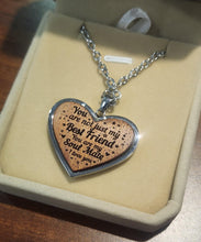 Load image into Gallery viewer, Heart-shaped pendant with engraved message on a beige box