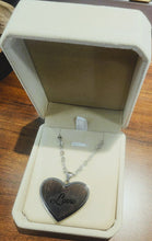 Load image into Gallery viewer, Heart-shaped pendant with 'Love' engraving in a jewelry box on a wooden surface